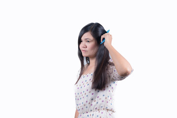 Woman combing her black hair. Isolated on white background.