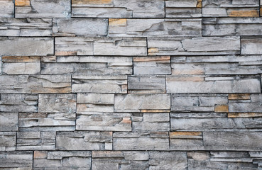Close up of modern style design decorative uneven cracked real stone wall surface with cement, old vintage