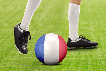 Foot of football player playing ball at field