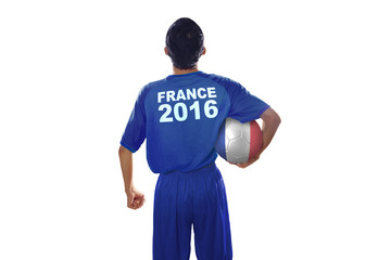 Fototapeta na wymiar Soccer player holds ball with a France flag