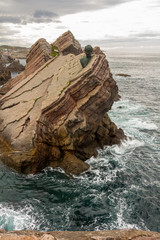 Monument on the rocks by the sea of Philippe Cousteau, Gijon, Spain