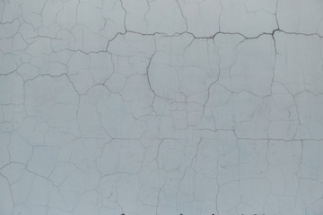 The texture of wall with cracks and blue paint