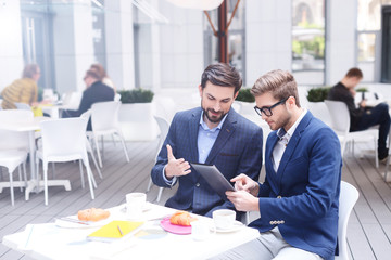 Successful businessmen are using gadget for work