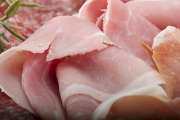 Wooden cutting board with various Italian salami