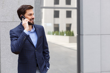 Attractive businessman is communicating on the telephone