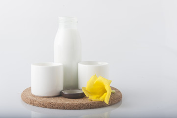 Milk with flower on white background