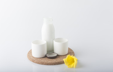 Fototapeta na wymiar Milk with flower on white background