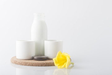 Milk with flower on white background