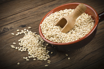 Spoon of Pearl barley close up on a table