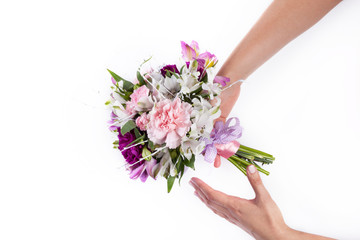 Giving a pink bouquet from gillyflowers and alstroemeria on whit
