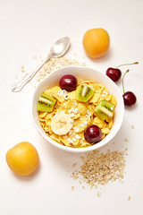 Healthy Breakfast with corn flakes, berry, apricot on white background.