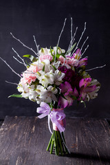 Pink bouquet from gillyflowers and alstroemeria on blackboard an