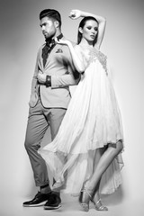 fashion sexy couple dressed elegant posing in the studio - bw - 113253132