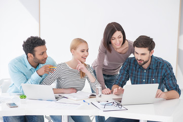 Group of young colleagues having meeting at office