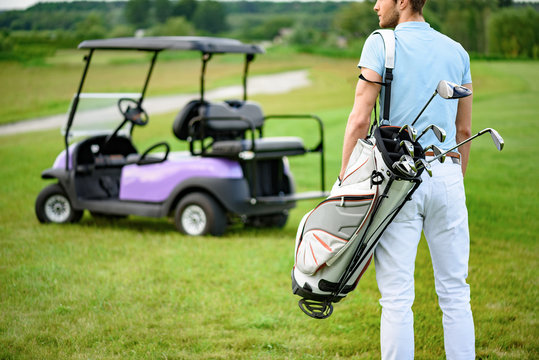 Golfer Walking With Golf Bags