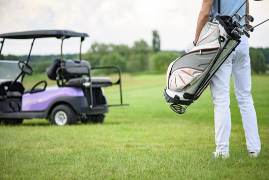 Golfer Walking With Golf Bags