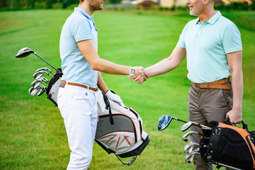 Golfers shake hands with each other - Powered by Adobe