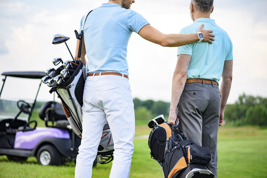 Two partners of game standing on golf course