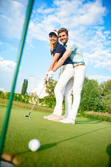 Young couple on golf course