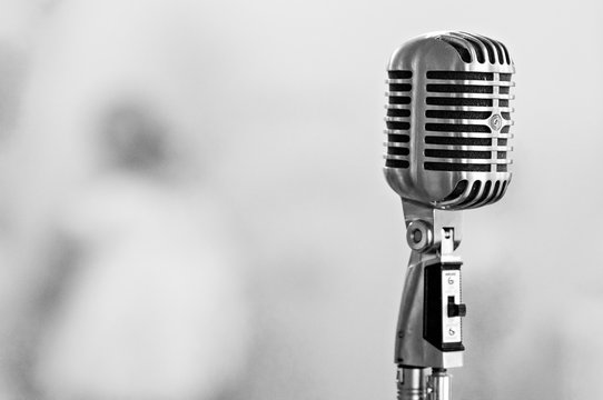 Retro microphone on light blurred background
