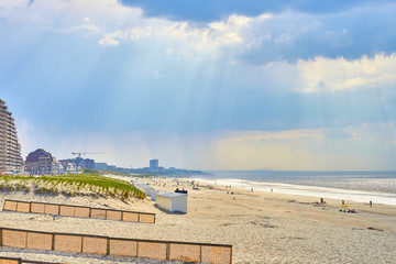 Sandy beach of North Sea / Roofed beach chairs at beach of Nieuwpoort in Belgium