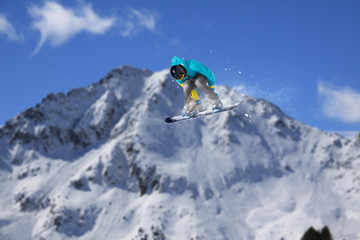 Naklejka na ściany i meble Snowboard rider jumping on mountains. Extreme freeride sport.