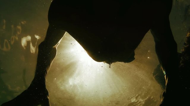 A view from underwater: a man dives into the waters of the Adriatic Sea