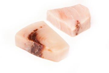 Swordfish steak portions isolated on a white studio background.