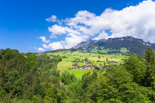 Summer view of Sigriswil village with Emmental Alps in the background