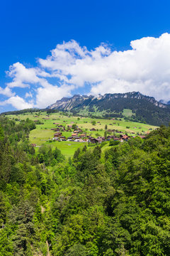 Summer view of Sigriswil village with Emmental Alps in the background
