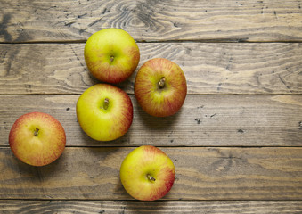 Red apples on a rustic wooden background