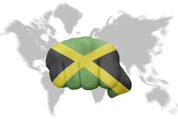 fist with the national flag of jamaica on a world map background