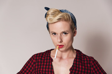pin up woman wearing a colorful makeup with cigarette in her mouth