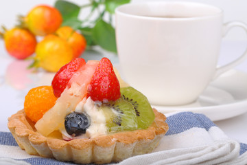 One fruit cake and teacup