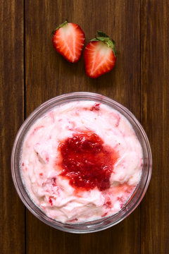 Strawberry Fool, An English Dessert Made Of Whipped Cream And Stewed Strawberries, Served In Glass Bowl, Photographed Overhead On Dark Wood With Natural Light