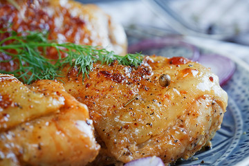 Roasted chicken and vegetables on dark wooden background