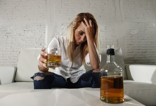 sad depressed alcoholic drunk woman drinking at home in housewife alcohol abuse and alcoholism