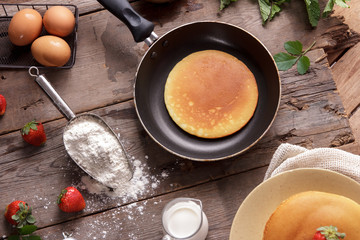 homemade pancake on pan with ingredients