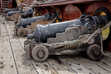row of cannons on galleon deck - obrazy, fototapety, plakaty