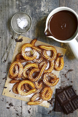 Traditional mexican dessert churros with chocolate sause.