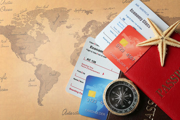 Fototapeta na wymiar Credit cards with passports and tickets for vacations on the world map background