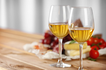 Glasses of wine with food on table closeup