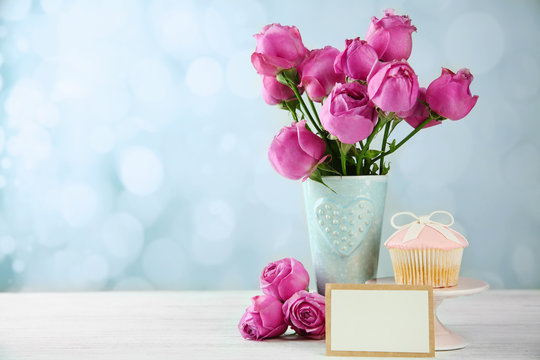 Mother Day concept. Roses with cupcake on bokeh background