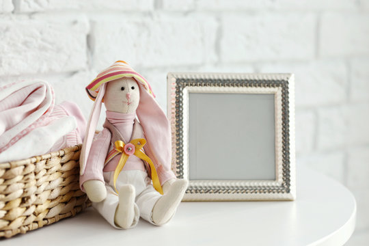 Baby Toy And Clothes On Brick Wall Background