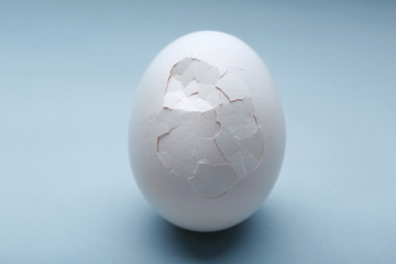 Cracked egg on grey background