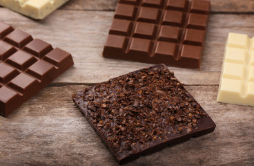 Chocolate bars on wooden background