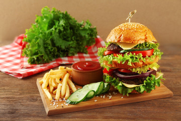 Hamburger with fries on wooden table
