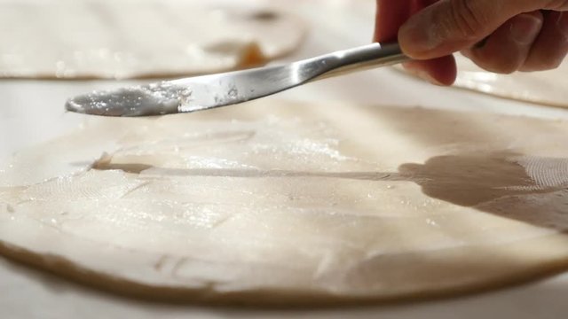 Hand puff pastry making with fat spreading over dough professional 4K 2160p UltraHD footage - Laminated dough layer on table spread butter 4K 3840X2160 UHD video
