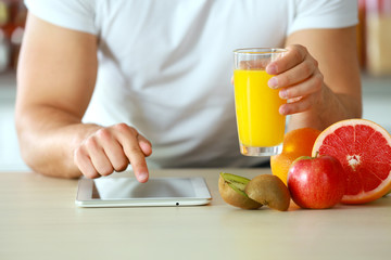 Man counting calories on tablet