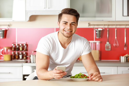 Man Eating Salad In The Kitchen